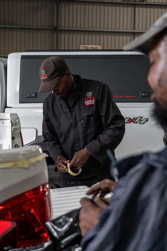 Auto Enhance team preparing a vehicle accessory for fitment